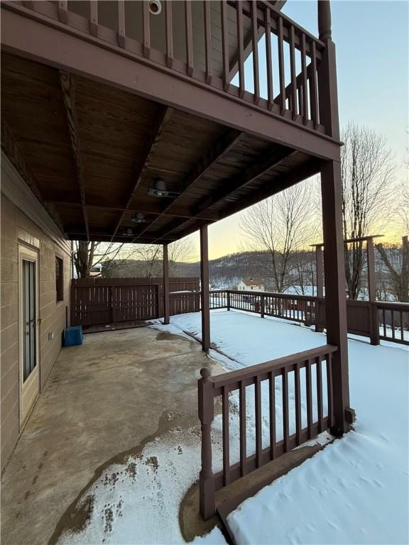 snow covered deck with a patio