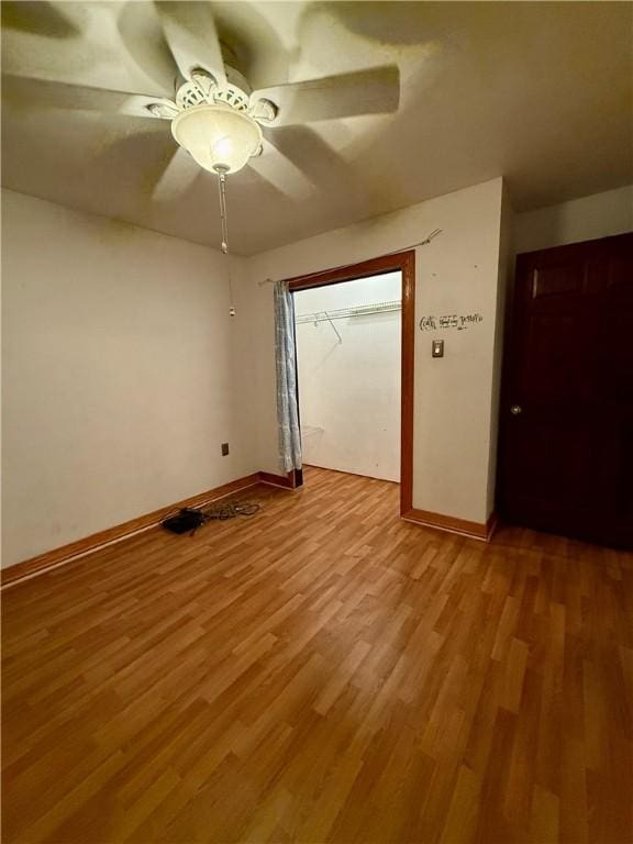 empty room with ceiling fan and light wood-type flooring