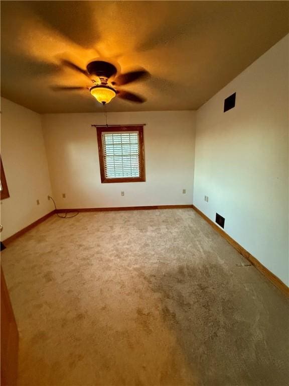 carpeted empty room with ceiling fan