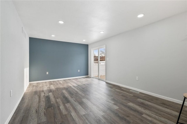 unfurnished room featuring dark hardwood / wood-style flooring