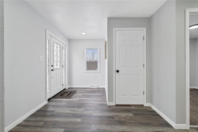 entryway with dark wood-type flooring