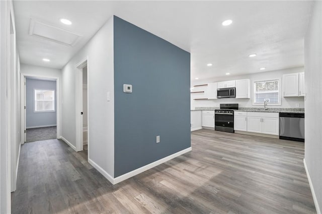 kitchen featuring stainless steel appliances, hardwood / wood-style flooring, sink, and white cabinets