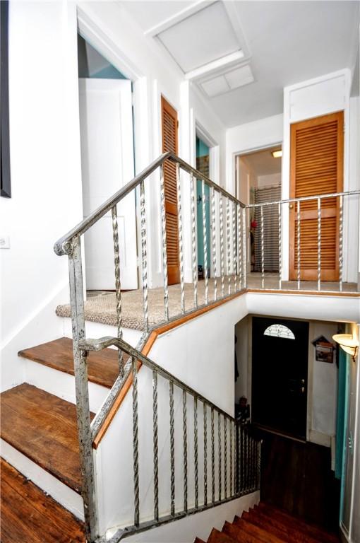 stairway with hardwood / wood-style floors