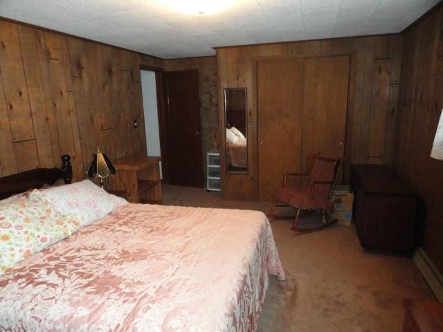 bedroom featuring carpet floors, wooden walls, and a closet