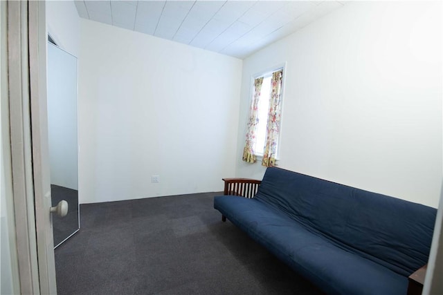 unfurnished room with dark colored carpet