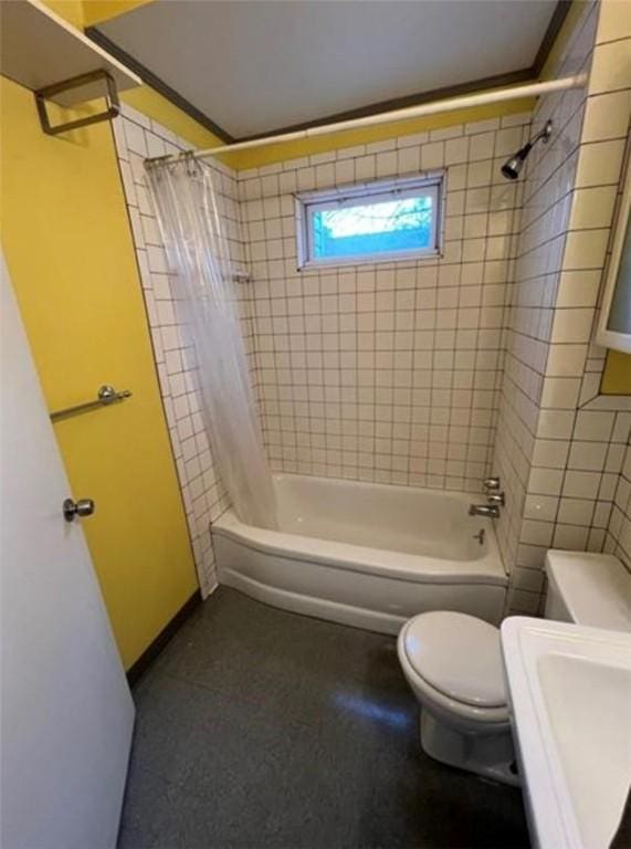 bathroom with shower / tub combo with curtain and toilet