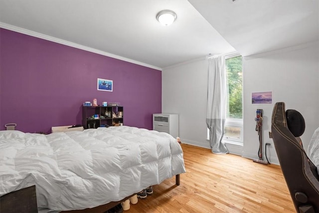 bedroom featuring crown molding and hardwood / wood-style floors