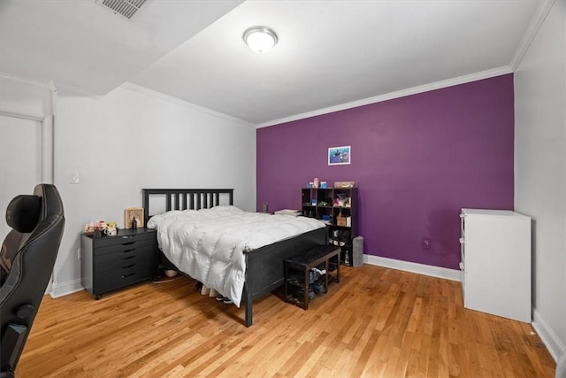 bedroom with hardwood / wood-style flooring and ornamental molding