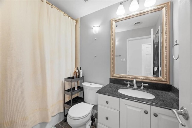 full bathroom with vanity, shower / tub combo, and toilet