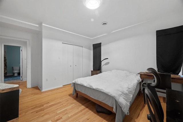 bedroom with a closet and light hardwood / wood-style flooring