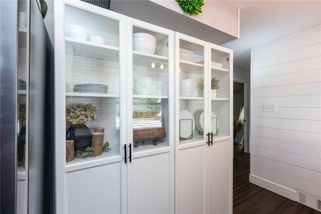 interior space featuring wood-type flooring and wood walls