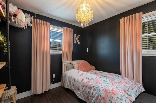 bedroom with a notable chandelier and dark hardwood / wood-style floors