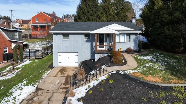 view of front of house featuring a garage and a front lawn