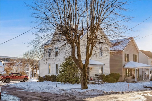 view of snowy exterior with a porch