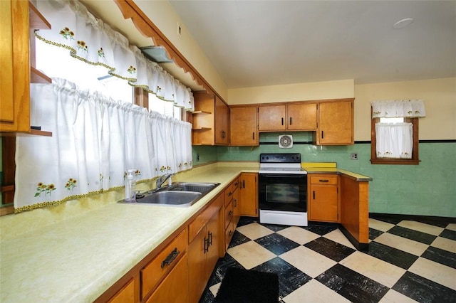 kitchen with tile walls, sink, and range with electric cooktop