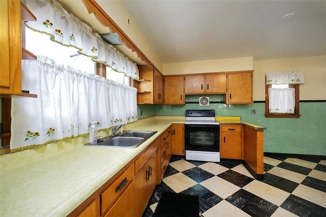 204 Liberty St, Perryopolis, PA 15473 - kitchen with electric stove, a sink, light flooring, light countertops, and brown cabinetry
