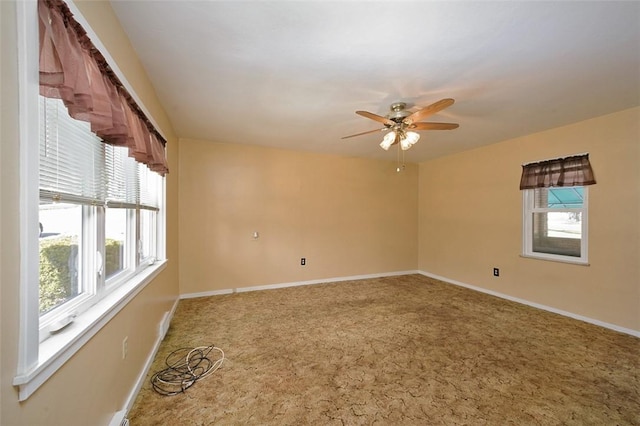 carpeted spare room with ceiling fan