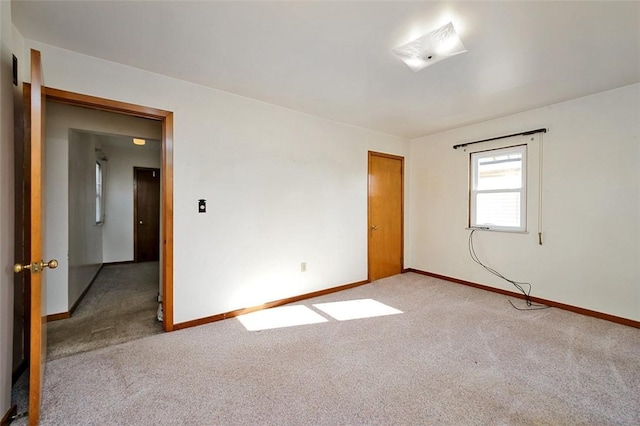 unfurnished room featuring light colored carpet