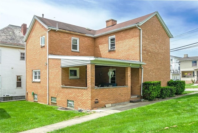 204 Liberty St, Perryopolis, PA 15473 - rear view of house with brick siding, a yard, a porch, and a chimney