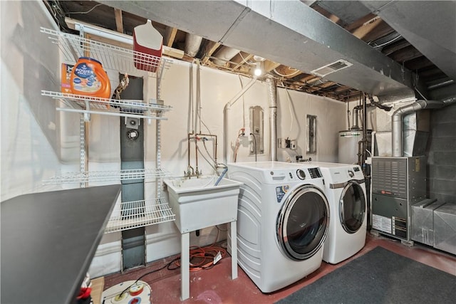 laundry room featuring sink, washing machine and dryer, and gas water heater