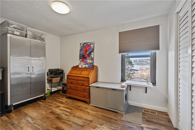 misc room with dark hardwood / wood-style floors and a textured ceiling