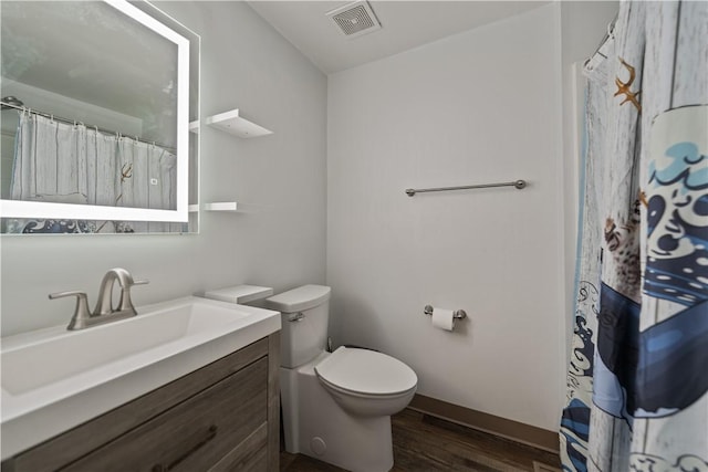 bathroom with vanity, hardwood / wood-style floors, and toilet