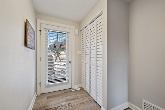 entryway with light hardwood / wood-style flooring