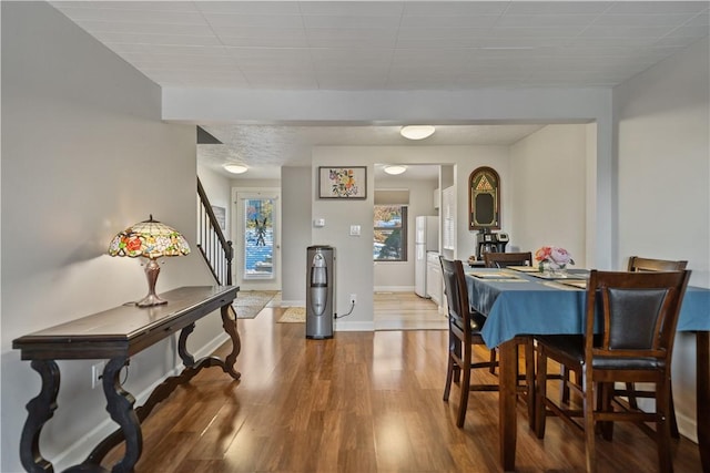 dining space featuring wood-type flooring