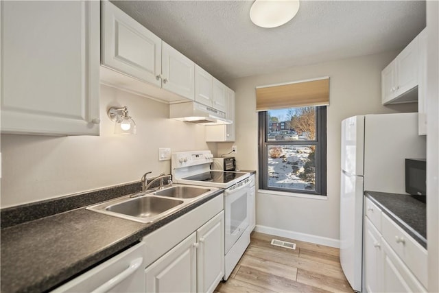 kitchen with sink, white appliances, light hardwood / wood-style flooring, white cabinetry, and a textured ceiling