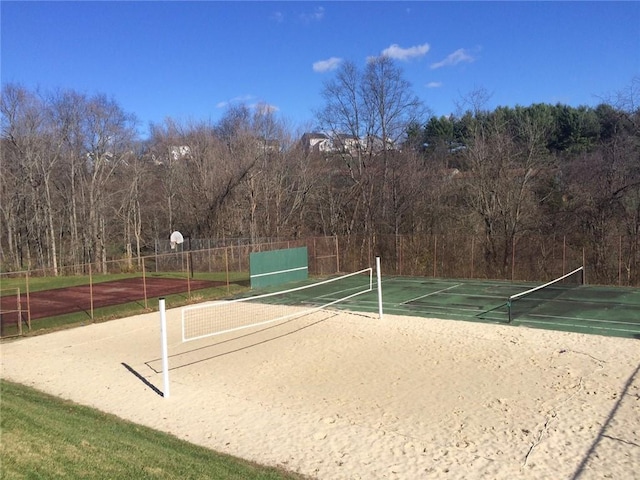 surrounding community with tennis court and basketball hoop