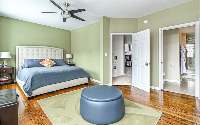 bedroom featuring ceiling fan, dark hardwood / wood-style flooring, and ensuite bath