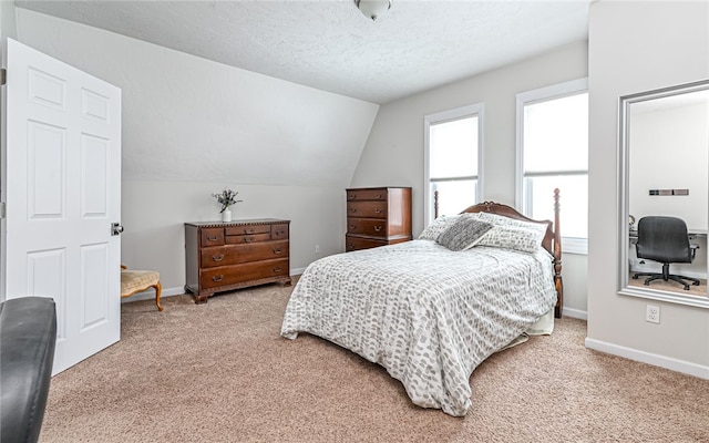 carpeted bedroom with lofted ceiling and a textured ceiling