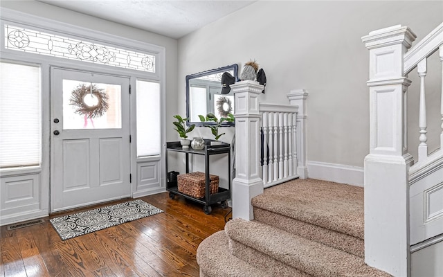 foyer entrance featuring dark wood-type flooring