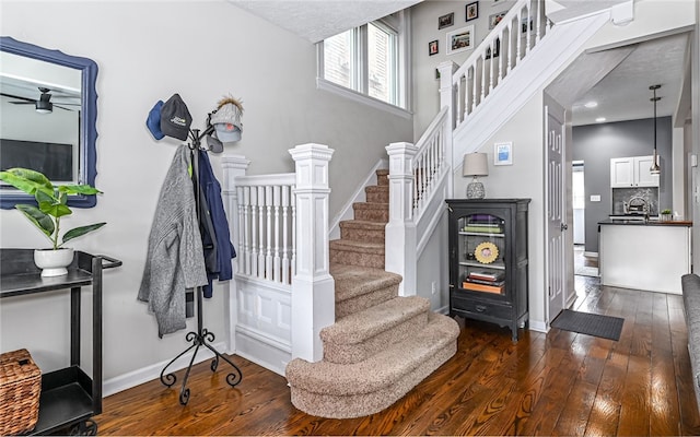 stairs with sink and hardwood / wood-style flooring