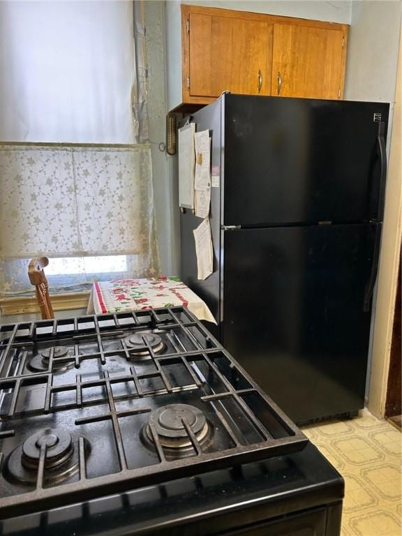 kitchen featuring backsplash and black appliances