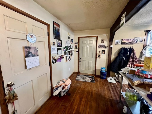 entryway with hardwood / wood-style floors and a textured ceiling