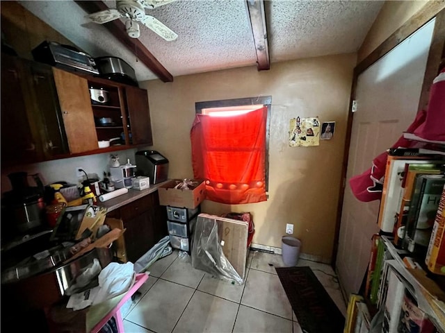 kitchen featuring light tile patterned flooring, ceiling fan, and a textured ceiling