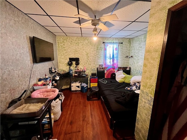 bedroom with dark hardwood / wood-style floors and a drop ceiling