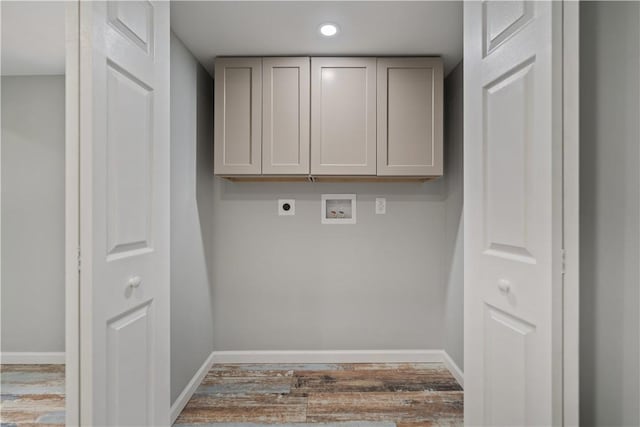 washroom with light wood-type flooring, cabinets, hookup for a washing machine, and electric dryer hookup