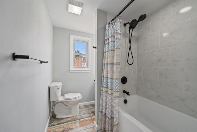 bathroom featuring toilet and shower / tub combo