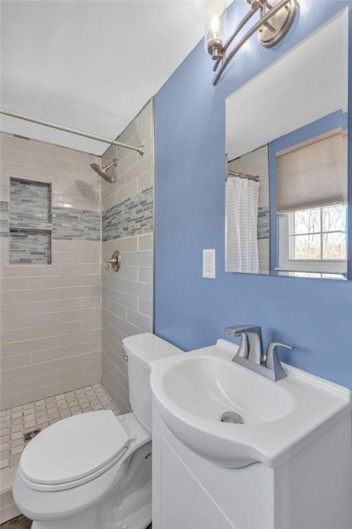 bathroom featuring vanity, toilet, and a shower with shower curtain