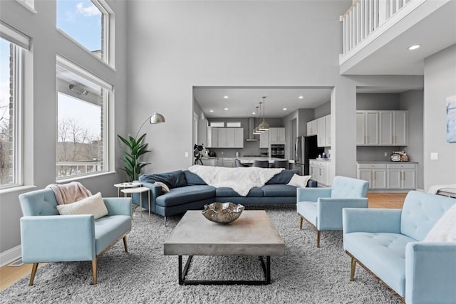 living room featuring a high ceiling and a wealth of natural light