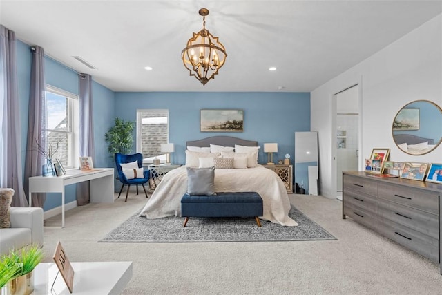 bedroom with light colored carpet and a chandelier