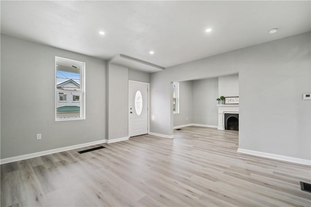 foyer entrance with light hardwood / wood-style floors