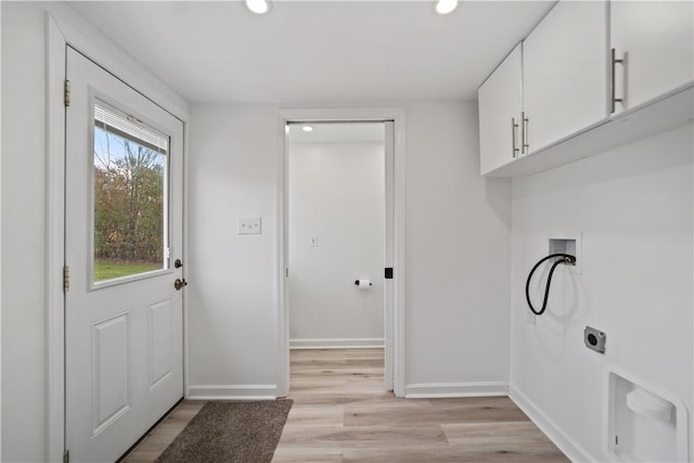 washroom featuring cabinets, washer hookup, electric dryer hookup, and light wood-type flooring