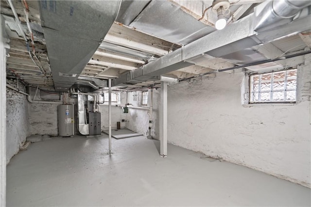 basement featuring water heater and heating unit