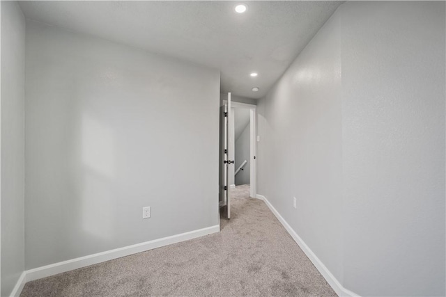 corridor with light colored carpet