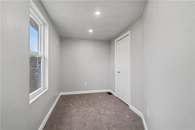 unfurnished room featuring carpet