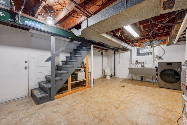 basement featuring washer / clothes dryer and sink