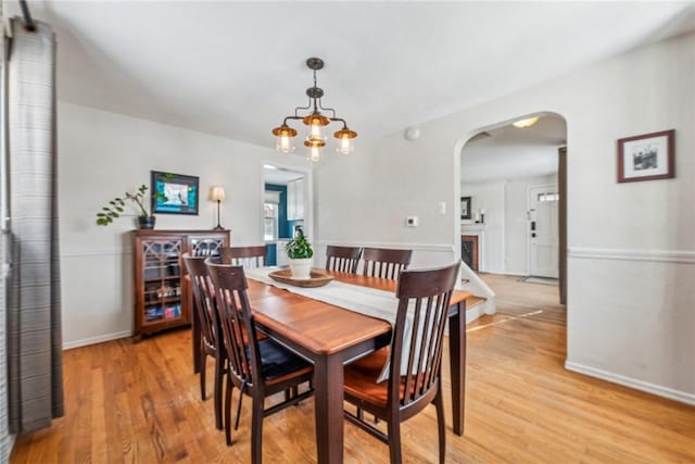 dining space with a chandelier and light wood-type flooring